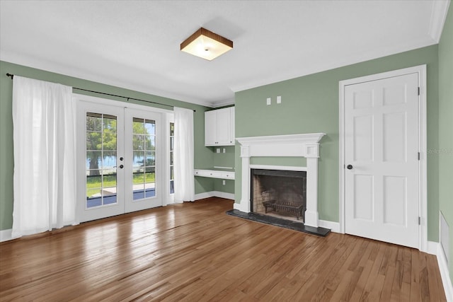 633 Balmoral Rd, Winter Park, FL 32789 - unfurnished living room featuring french doors, wood finished floors, a fireplace with raised hearth, and baseboards