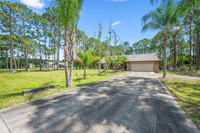 4206 Hield Rd NW, Palm Bay, FL 32907 - view of front of house with concrete driveway, a garage, and a front yard