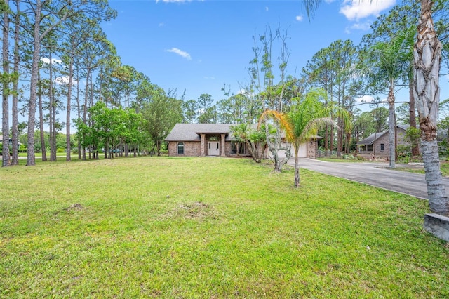 4206 Hield Rd NW, Palm Bay, FL 32907 - view of front facade featuring driveway, an attached garage, and a front yard