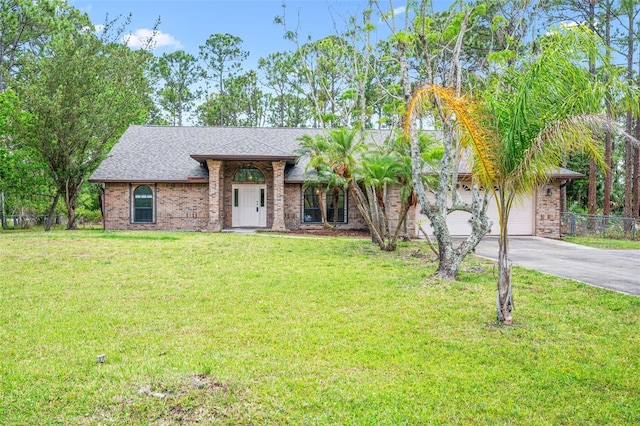 4206 Hield Rd NW, Palm Bay, FL 32907 - view of front of home featuring driveway, brick siding, an attached garage, and roof with shingles