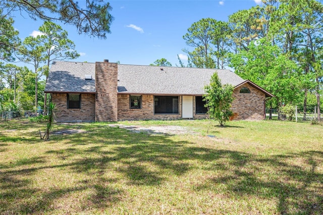 4206 Hield Rd NW, Palm Bay, FL 32907 - rear view of property with brick siding, a shingled roof, and a chimney