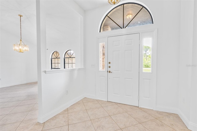 4206 Hield Rd NW, Palm Bay, FL 32907 - entryway with a chandelier, light tile patterned flooring, and baseboards