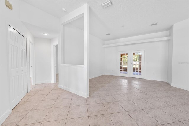 4206 Hield Rd NW, Palm Bay, FL 32907 - spare room featuring light tile patterned floors, french doors, and baseboards