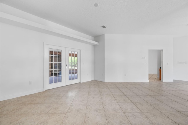 4206 Hield Rd NW, Palm Bay, FL 32907 - unfurnished room with french doors, a textured ceiling, and light tile patterned floors