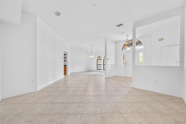 4206 Hield Rd NW, Palm Bay, FL 32907 - empty room featuring a chandelier, light tile patterned flooring, and baseboards