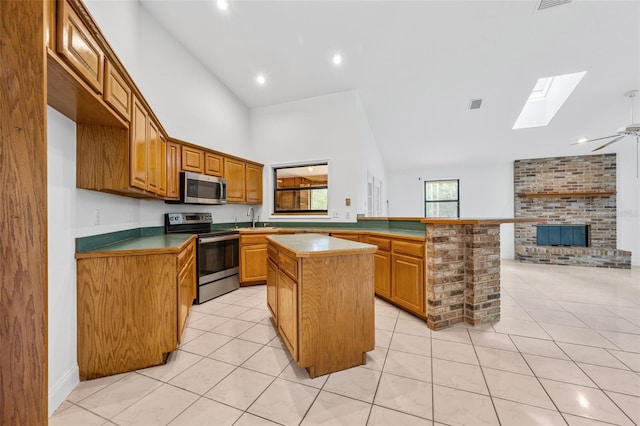 4206 Hield Rd NW, Palm Bay, FL 32907 - kitchen with appliances with stainless steel finishes, a skylight, open floor plan, a kitchen island, and a sink