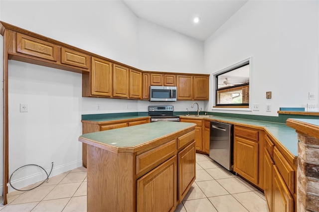 4206 Hield Rd NW, Palm Bay, FL 32907 - kitchen featuring stainless steel appliances, high vaulted ceiling, a sink, light tile patterned floors, and brown cabinetry