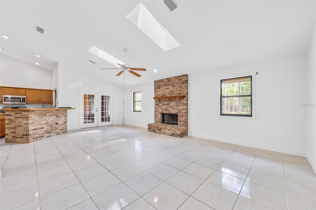 4206 Hield Rd NW, Palm Bay, FL 32907 - unfurnished living room with a skylight, plenty of natural light, light tile patterned flooring, recessed lighting, and high vaulted ceiling
