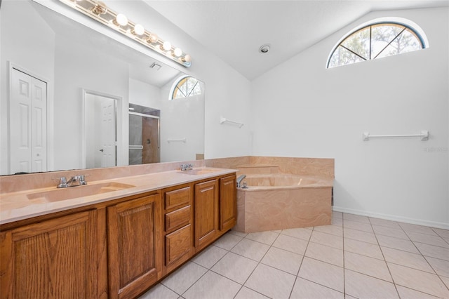 4206 Hield Rd NW, Palm Bay, FL 32907 - full bathroom featuring vaulted ceiling, tile patterned floors, a stall shower, double vanity, and a garden tub