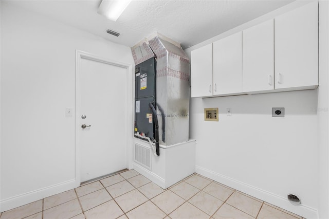 4206 Hield Rd NW, Palm Bay, FL 32907 - laundry room featuring hookup for an electric dryer, hookup for a washing machine, cabinet space, baseboards, and light tile patterned floors