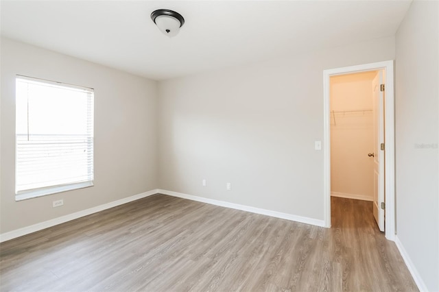 24237 Rolling View Ct, Lutz, FL 33559 - empty room with light wood-style floors and baseboards