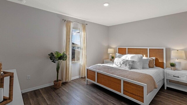 bedroom with wood finished floors and baseboards