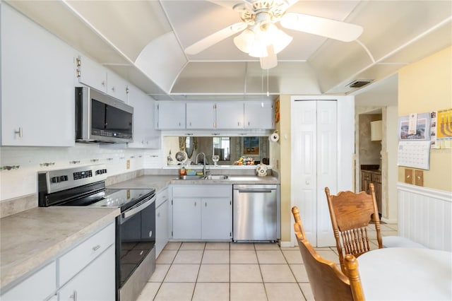 6 Escondido Cir Unit 55, Altamonte Springs, FL 32701 - kitchen with appliances with stainless steel finishes, a sink, a ceiling fan, light countertops, and light tile patterned flooring