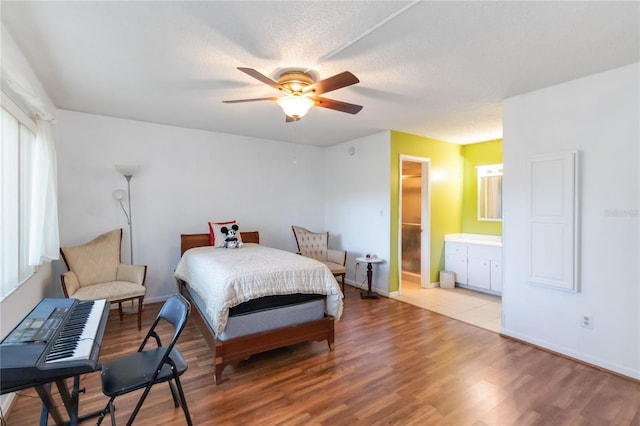 6 Escondido Cir Unit 55, Altamonte Springs, FL 32701 - bedroom featuring wood finished floors, baseboards, a ceiling fan, and connected bathroom