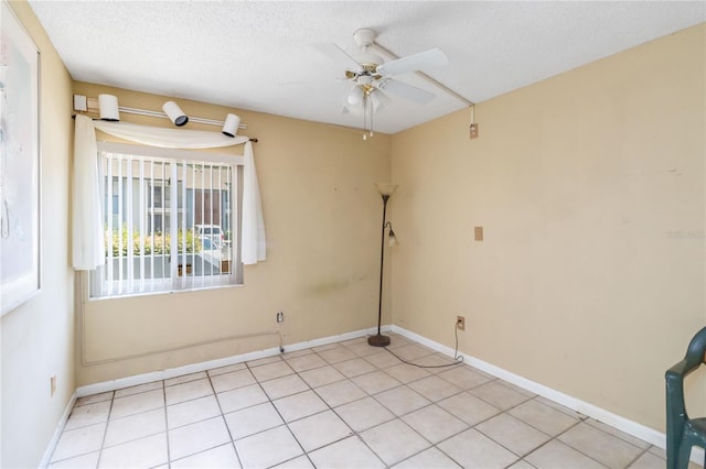 6 Escondido Cir Unit 55, Altamonte Springs, FL 32701 - spare room featuring a ceiling fan, baseboards, light tile patterned floors, and a textured ceiling
