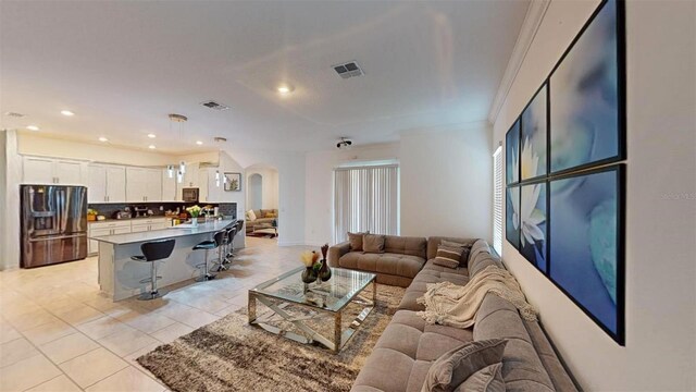 8851 Fallen Oak Dr, Davenport, FL 33896 - living area with arched walkways, recessed lighting, light tile patterned flooring, and baseboards