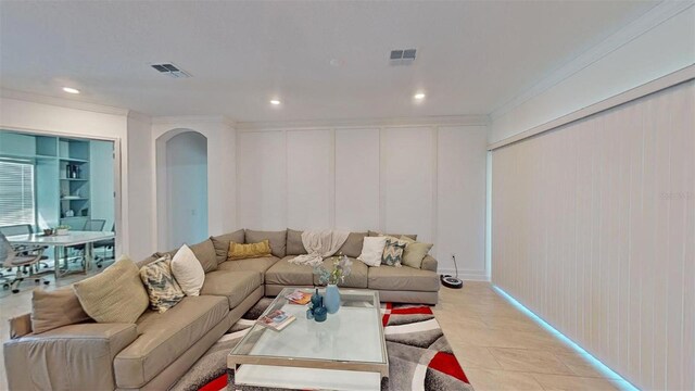 8851 Fallen Oak Dr, Davenport, FL 33896 - living room featuring a decorative wall, recessed lighting, ornamental molding, and arched walkways