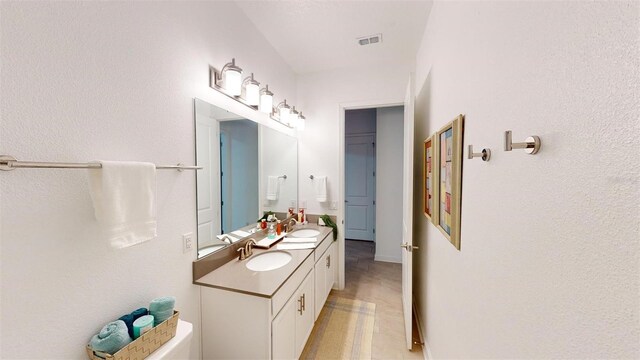 8851 Fallen Oak Dr, Davenport, FL 33896 - bathroom with double vanity and baseboards