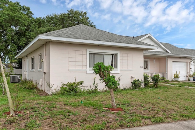 3162 Little Sound Dr, Orlando, FL 32827 - view of property exterior featuring roof with shingles, an attached garage, a lawn, and central air condition unit
