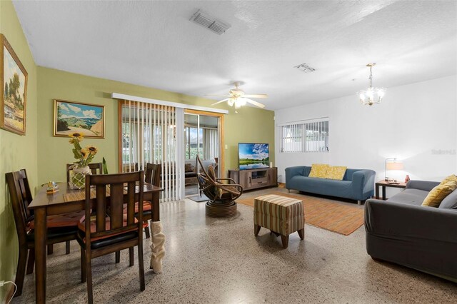 3162 Little Sound Dr, Orlando, FL 32827 - living room with speckled floor, a chandelier, and ceiling fan