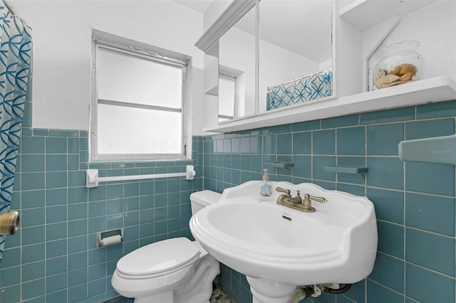 3162 Little Sound Dr, Orlando, FL 32827 - full bathroom featuring tile walls, wainscoting, toilet, and a sink