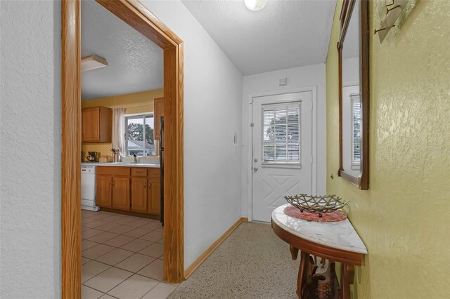 3162 Little Sound Dr, Orlando, FL 32827 - hall featuring a textured wall, a textured ceiling, and baseboards