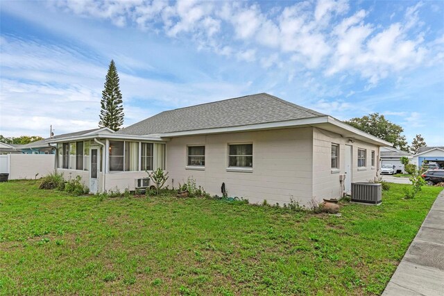 3162 Little Sound Dr, Orlando, FL 32827 - view of home's exterior with central AC unit, a sunroom, and a shingled roof