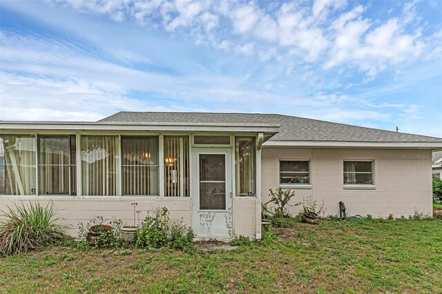 3162 Little Sound Dr, Orlando, FL 32827 - view of front facade featuring a sunroom, a shingled roof, and a front yard