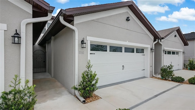 8560 Magnificent Ln, Groveland, FL 34736 - view of side of property featuring stucco siding, an attached garage, and concrete driveway