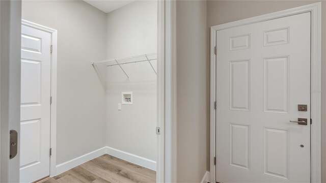 8560 Magnificent Ln, Groveland, FL 34736 - laundry area featuring light wood finished floors, washer hookup, and baseboards
