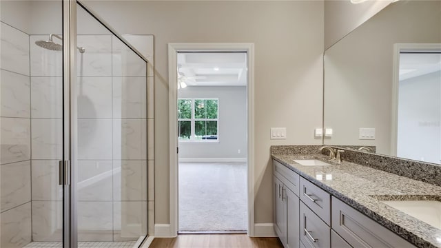 8560 Magnificent Ln, Groveland, FL 34736 - full bath with a stall shower, wood finished floors, double vanity, and baseboards