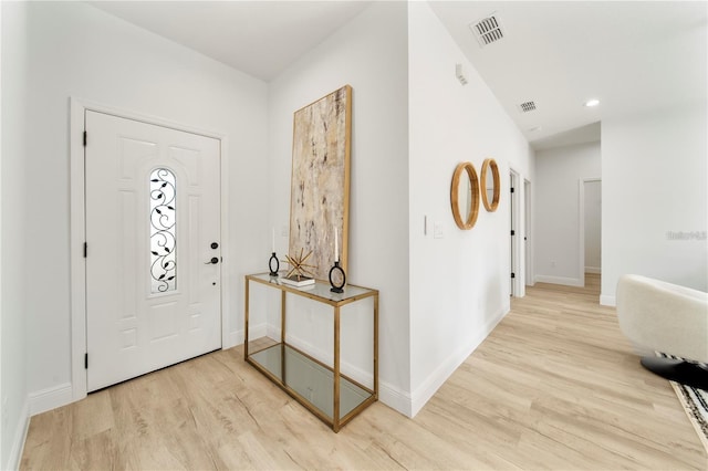 foyer featuring wood finished floors, baseboards, and recessed lighting