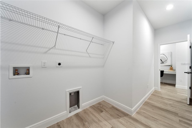 clothes washing area with electric dryer hookup, washer hookup, light wood-style floors, and baseboards