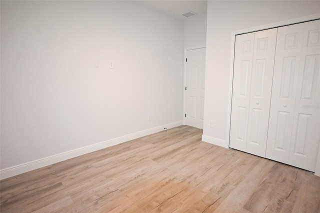 921 Sable Cir SE, Palm Bay, FL 32909 - unfurnished bedroom featuring light wood finished floors, baseboards, and a closet