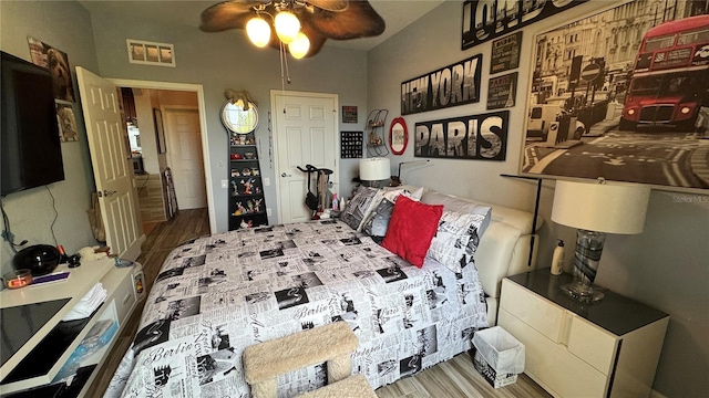 bedroom with wood finished floors and a ceiling fan