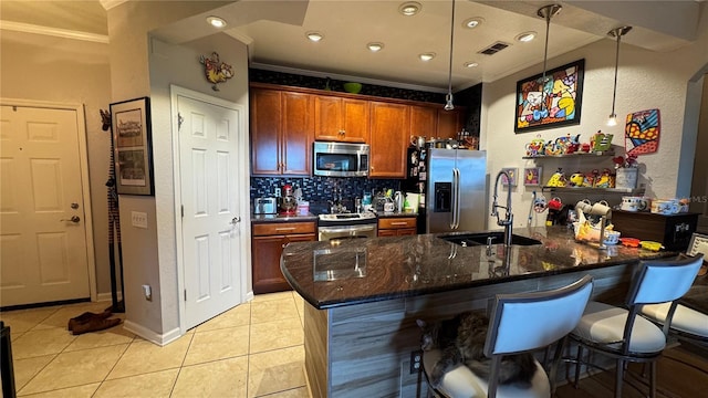 kitchen with appliances with stainless steel finishes, crown molding, light tile patterned floors, a kitchen bar, and backsplash