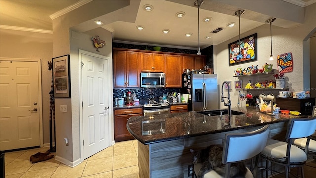 kitchen featuring appliances with stainless steel finishes, a sink, ornamental molding, light tile patterned floors, and decorative backsplash