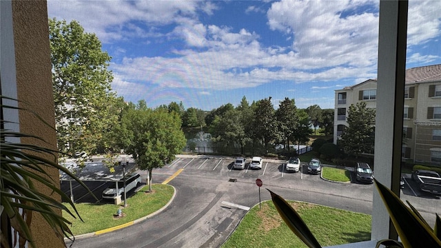 view of asphalt road featuring curbs