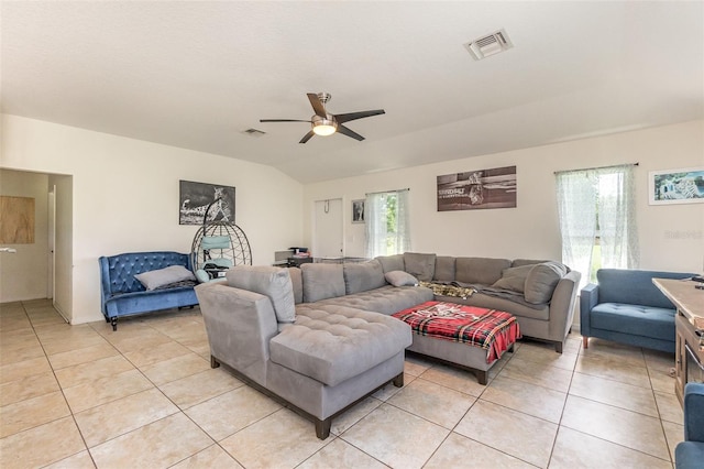 living room with light tile patterned floors, a ceiling fan, and vaulted ceiling