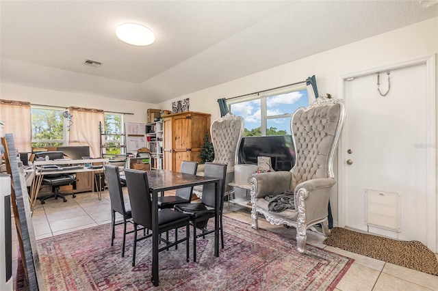 dining area with light tile patterned floors and a desk