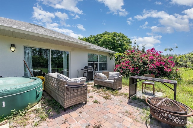 view of patio with an outdoor living space with a fire pit and a grill