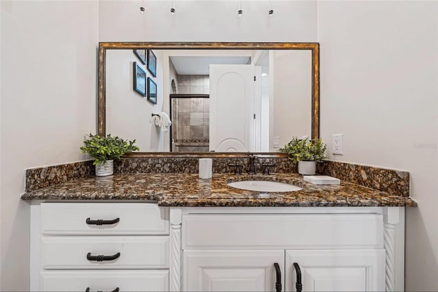 full bathroom with vanity and a tile shower