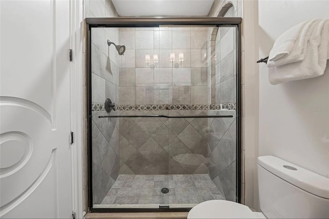 full bathroom with toilet and a stall shower