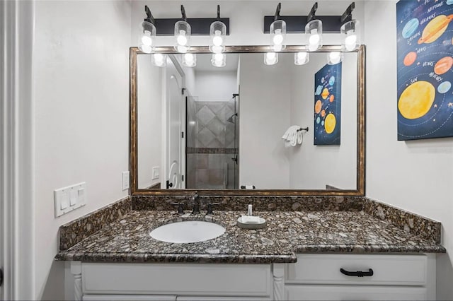 bathroom featuring a shower stall and vanity