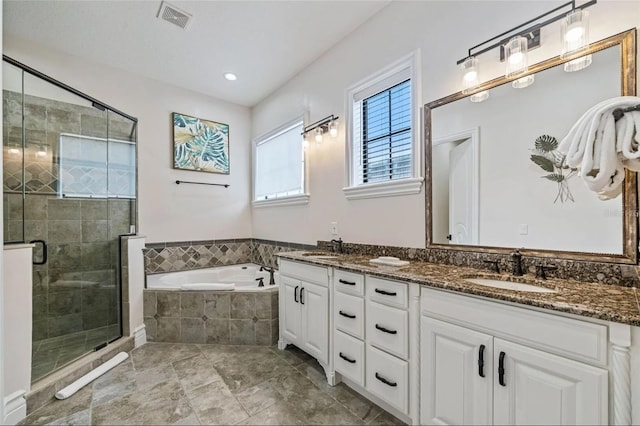 full bathroom with a garden tub, double vanity, and a stall shower