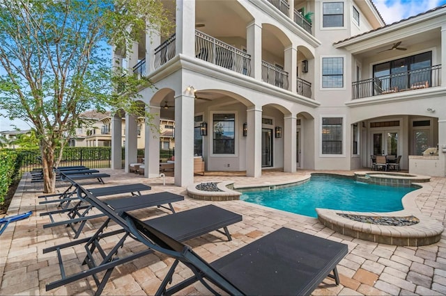 view of pool with an outdoor fire pit, a patio area, a ceiling fan, and fence