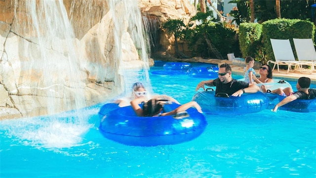 community pool featuring a water play area