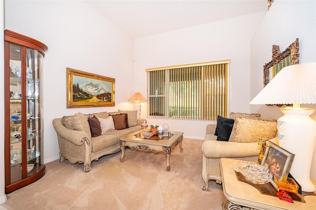 living room featuring carpet floors, baseboards, and high vaulted ceiling