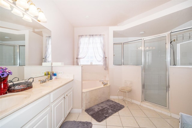 full bath featuring tile patterned flooring, a shower stall, a garden tub, and double vanity