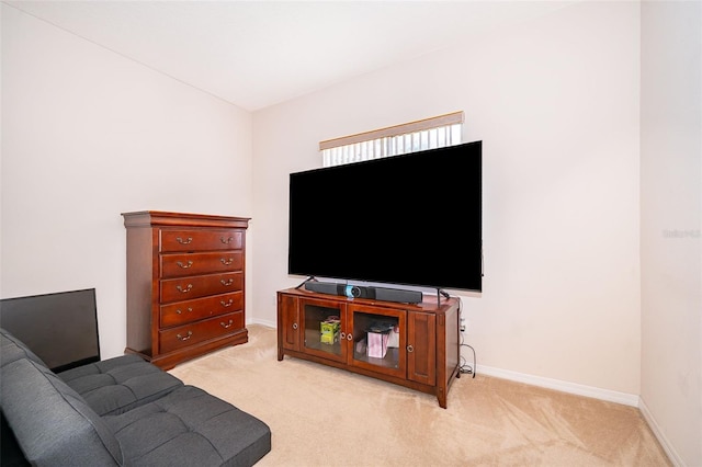 living room featuring light carpet and baseboards